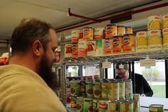 Workers stock shelves at the Titans Feeding Titans food pantry.